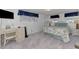 Bedroom with a patterned bedspread, desk, and wicker chair; natural light at 714 N Waterway Dr, Venice, FL 34285