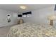 A bedroom featuring an adjoining bathroom and built-in desk area at 714 N Waterway Dr, Venice, FL 34285