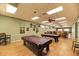 Billiard room featuring pool tables with elegant lighting and comfortable seating, creating a sophisticated ambiance at 714 N Waterway Dr, Venice, FL 34285