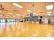 Spacious clubhouse with a stage, hardwood dance floor, and large windows, ideal for events and gatherings at 714 N Waterway Dr, Venice, FL 34285
