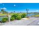 Charming community entrance with designated golf cart parking and serene waterfront views with boat docks at 714 N Waterway Dr, Venice, FL 34285