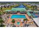 Overhead shot of the community pool and clubhouse with ample lounge chairs and tables for residents at 714 N Waterway Dr, Venice, FL 34285