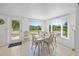 Bright dining area with a glass-top table, wicker chairs, and views of the waterfront at 714 N Waterway Dr, Venice, FL 34285