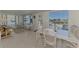 Bright dining area with wicker furniture and large windows showcasing the outdoors at 714 N Waterway Dr, Venice, FL 34285
