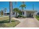 Charming single story home with carport, sidewalk, and tropical landscaping at 714 N Waterway Dr, Venice, FL 34285