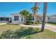 Inviting single story home with comfortable outdoor seating on front patio at 714 N Waterway Dr, Venice, FL 34285