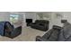 Living room with black leather furniture and a view into the bright dining area at 714 N Waterway Dr, Venice, FL 34285