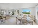Inviting living room and dining room with tile floors and serene waterfront views at 714 N Waterway Dr, Venice, FL 34285