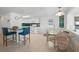 Open living space featuring a breakfast bar area and a dining room, all with tile flooring at 714 N Waterway Dr, Venice, FL 34285