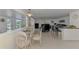 Open-concept living space featuring a dining area and comfortable seating, with waterfront views and tile flooring at 714 N Waterway Dr, Venice, FL 34285