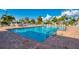 Large outdoor swimming pool with poolside lounge chairs and lush palm trees surrounding the area at 714 N Waterway Dr, Venice, FL 34285