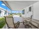 Covered porch with seating provides a relaxing outdoor space at this charming home at 714 N Waterway Dr, Venice, FL 34285