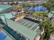Aerial view of the community shuffleboard courts, featuring covered seating and meticulously maintained green playing surfaces at 714 N Waterway Dr, Venice, FL 34285