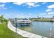 Picturesque canal view featuring a boat dock with a large boat, perfect for waterfront living and boating enthusiasts at 714 N Waterway Dr, Venice, FL 34285