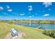 Scenic waterfront property featuring docks, boats, and lush green landscaping under a bright blue sky at 714 N Waterway Dr, Venice, FL 34285