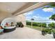 Relaxing condo balcony featuring comfortable seating and stunning waterfront views through a glass railing at 76 Tidy Island Blvd, Bradenton, FL 34210