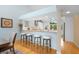 Stylish bar area featuring seating, granite countertops, white cabinets, and views of the yard at 76 Tidy Island Blvd, Bradenton, FL 34210