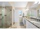 Bathroom features double sinks, granite countertops, and a tiled glass shower at 76 Tidy Island Blvd, Bradenton, FL 34210