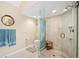 Bright bathroom featuring neutral tile, a glass enclosed shower and a modern toilet at 76 Tidy Island Blvd, Bradenton, FL 34210