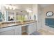Bright bathroom with a large mirror over double sinks and a countertop vanity area at 76 Tidy Island Blvd, Bradenton, FL 34210