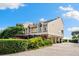 Beautifully landscaped two-story home with a neutral color scheme and elevated design at 76 Tidy Island Blvd, Bradenton, FL 34210