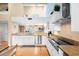 Bright, open kitchen with stainless steel appliances, granite counters, and seamless access to living area at 76 Tidy Island Blvd, Bradenton, FL 34210