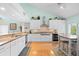 Bright, open kitchen with stainless steel appliances, countertops, and vaulted ceilings at 76 Tidy Island Blvd, Bradenton, FL 34210