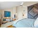 Well-lit bedroom showcasing unique wall art, cozy seating, and bright, neutral paint at 76 Tidy Island Blvd, Bradenton, FL 34210