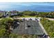 Community tennis courts surrounded by lush greenery with bay views at 76 Tidy Island Blvd, Bradenton, FL 34210