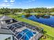 Aerial view of house with screened in pool area and lake at 7832 Panther Ridge Trl, Bradenton, FL 34202