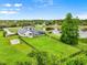 Aerial view of the property showcasing the house, fenced backyard, and water view at 7832 Panther Ridge Trl, Bradenton, FL 34202