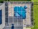 Aerial view of the backyard pool and screened enclosure with manicured lawn and landscaping at 7832 Panther Ridge Trl, Bradenton, FL 34202
