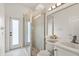 Bright bathroom features glass shower, sink, toilet, mirror, and white walls at 7832 Panther Ridge Trl, Bradenton, FL 34202