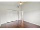Bright bedroom features wood floors, closet, ceiling fan and an open doorway at 7832 Panther Ridge Trl, Bradenton, FL 34202