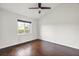 This bedroom features a hardwood floor, a ceiling fan, and a window to let in the sunlight at 7832 Panther Ridge Trl, Bradenton, FL 34202