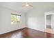 Bright bedroom features wood floors, window with backyard views, and white walls at 7832 Panther Ridge Trl, Bradenton, FL 34202