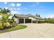 Beautiful home featuring a 3-car garage, landscaped garden, and a wide driveway for ample parking at 7832 Panther Ridge Trl, Bradenton, FL 34202