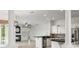 Open-concept kitchen with black countertops, white cabinets, and stainless steel appliances at 7832 Panther Ridge Trl, Bradenton, FL 34202