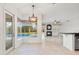 Bright living room with a view of the screened-in pool, fireplace, and kitchen at 7832 Panther Ridge Trl, Bradenton, FL 34202