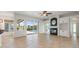 Spacious living room with tile flooring, a fireplace, and sliding glass doors leading to the pool at 7832 Panther Ridge Trl, Bradenton, FL 34202