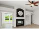 Living room featuring a decorative fireplace with dark tile surround and built-in cabinets at 7832 Panther Ridge Trl, Bradenton, FL 34202