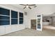 Living room featuring a cozy fireplace and custom built-in shelving with ample natural light at 7832 Panther Ridge Trl, Bradenton, FL 34202