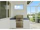 Outdoor kitchen with a built-in grill and counter space, ideal for outdoor cooking at 7832 Panther Ridge Trl, Bradenton, FL 34202