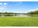 The manicured backyard has a pond view at 7832 Panther Ridge Trl, Bradenton, FL 34202