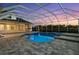 Backyard with a screened-in pool and patio area, perfect for outdoor entertaining with sunset views at 7832 Panther Ridge Trl, Bradenton, FL 34202