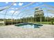 Large screened-in pool with an attached spa and paver decking at 7832 Panther Ridge Trl, Bradenton, FL 34202