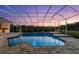 Beautiful screened-in pool and spa overlooking serene landscaping and a lovely sunset at 7832 Panther Ridge Trl, Bradenton, FL 34202