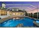 Beautiful backyard with a screened-in pool, patio, and lush landscaping and outdoor kitchen at 7832 Panther Ridge Trl, Bradenton, FL 34202