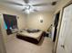 Simple bedroom with tile floors and a ceiling fan, providing a comfortable space at 815 12Th W Ave, Bradenton, FL 34205
