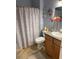Well-lit bathroom with a seashell-themed shower curtain and decor at 817 Tallgrass Ln, Bradenton, FL 34212